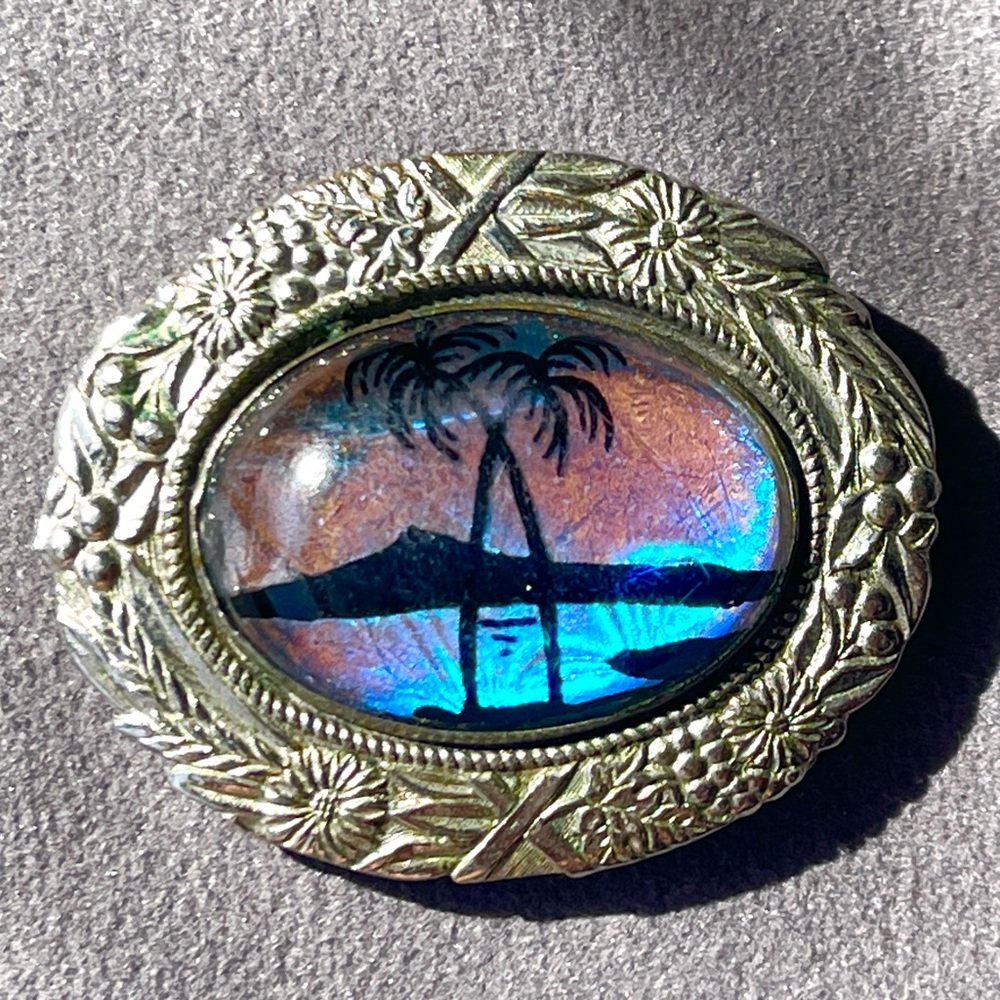 Vintage painted butterfly wing in ornate silver setting brooch with twin palms